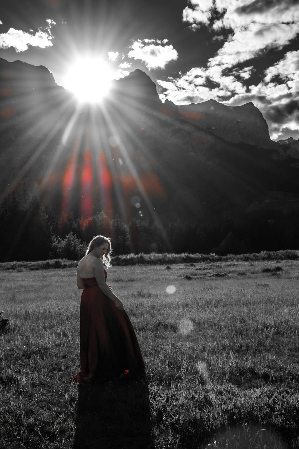 Julia silhouetted against the setting sun over the mountains
